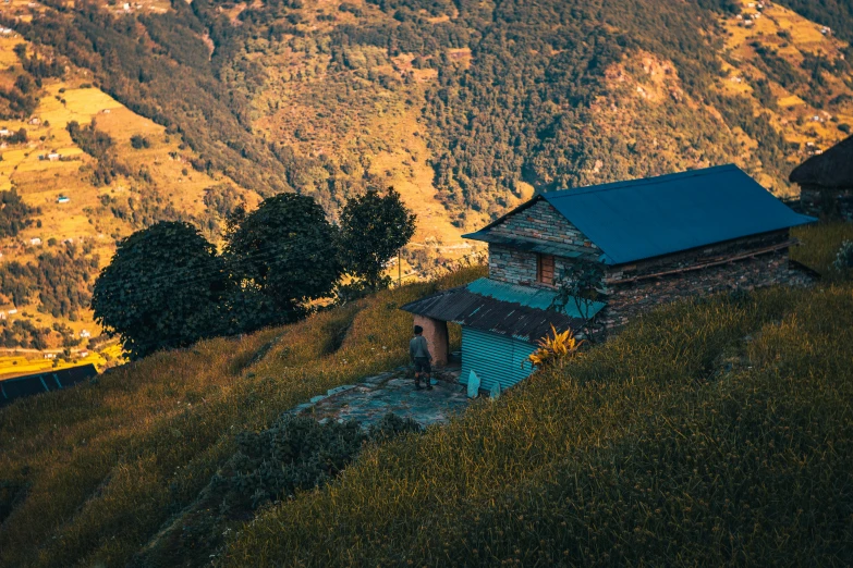 an old building sits in the hills near the water