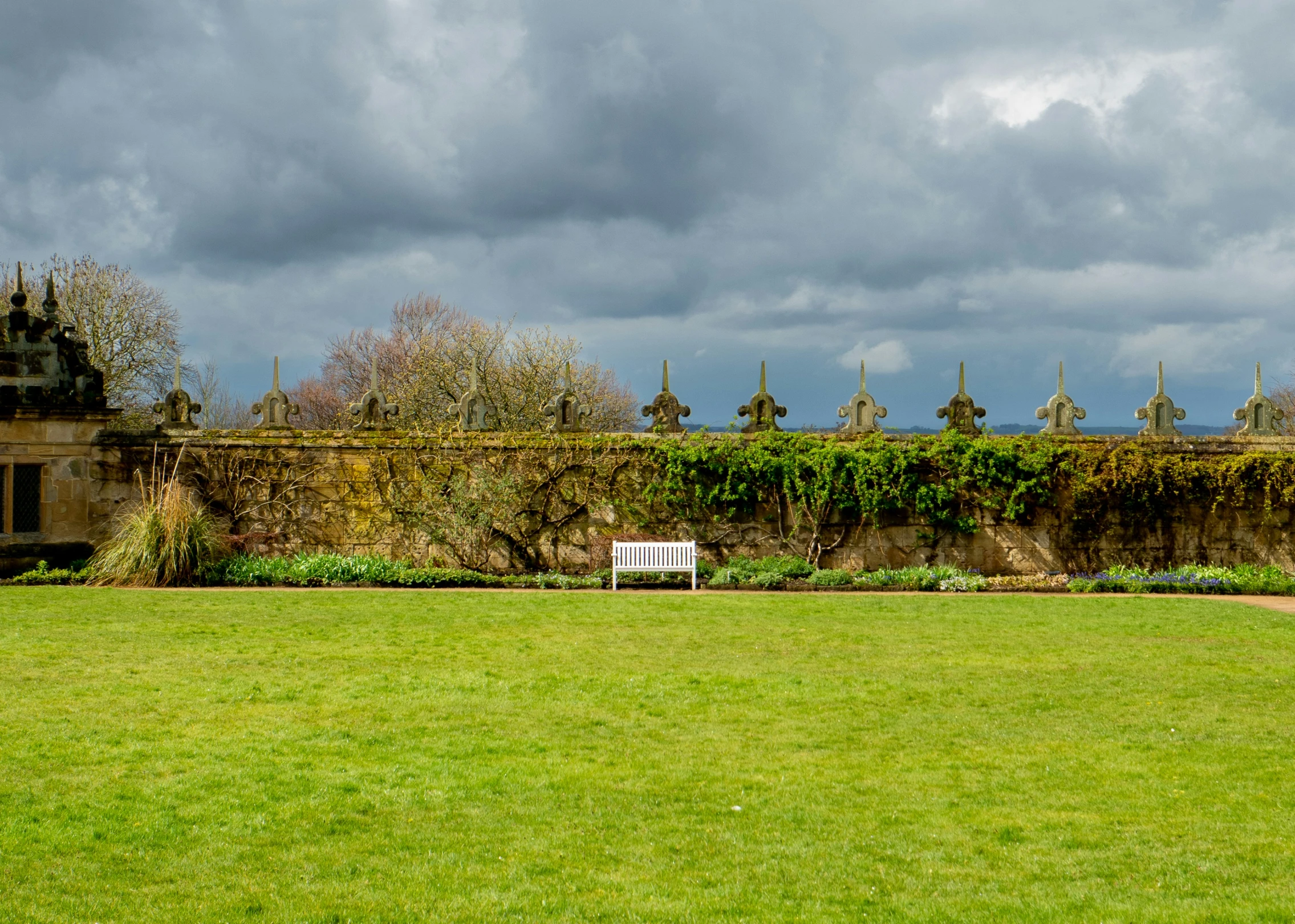 a bench sitting on top of a lush green field