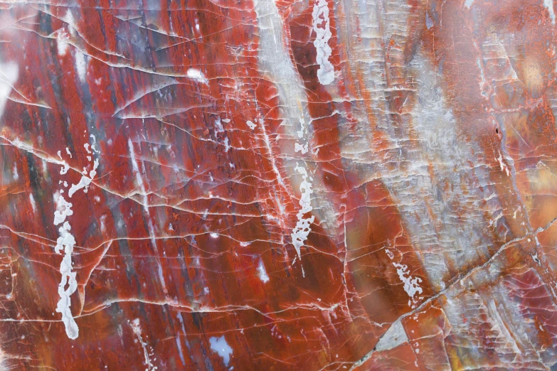 closeup of an orange rock with s and paint