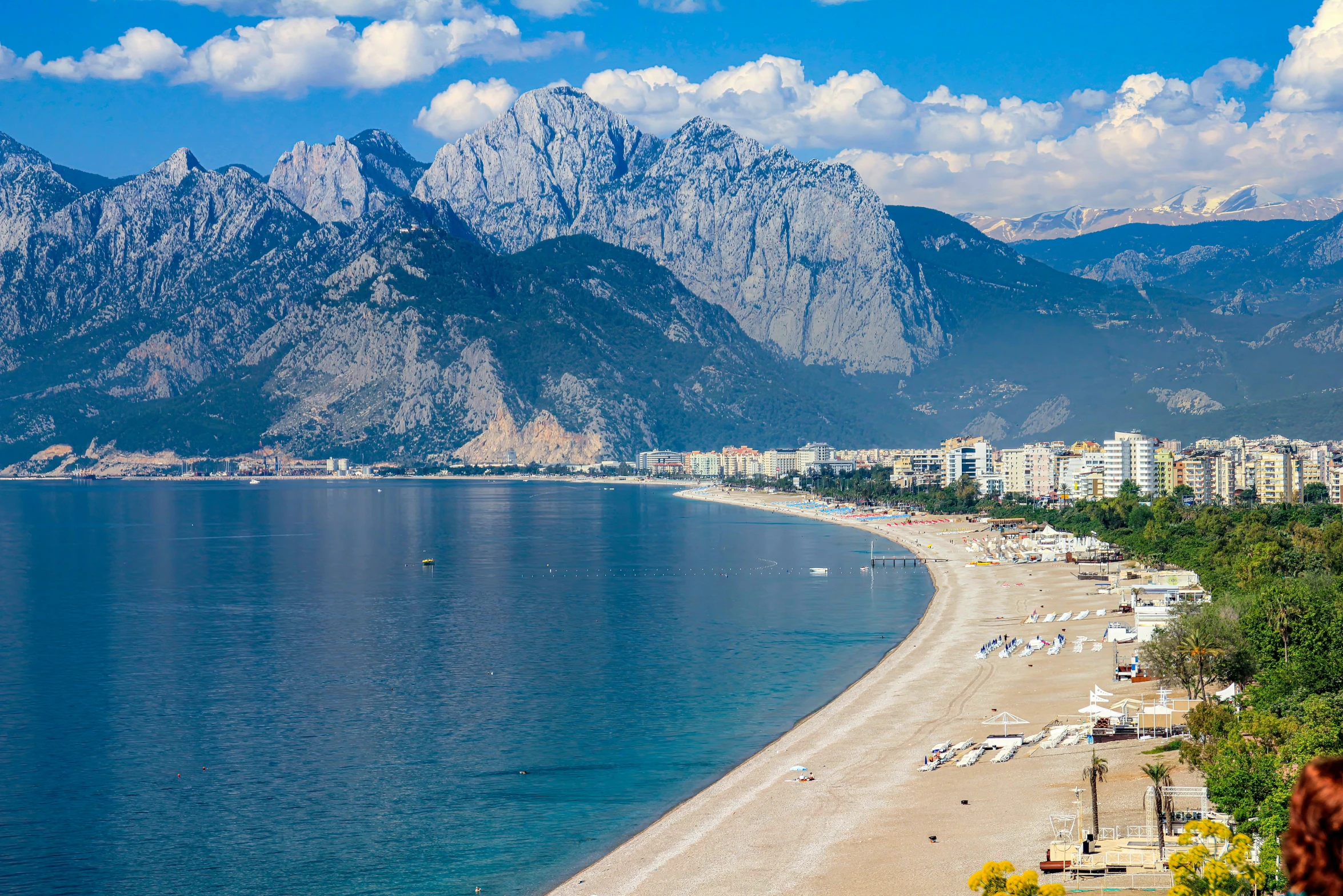 a view of the beach, mountains and ocean