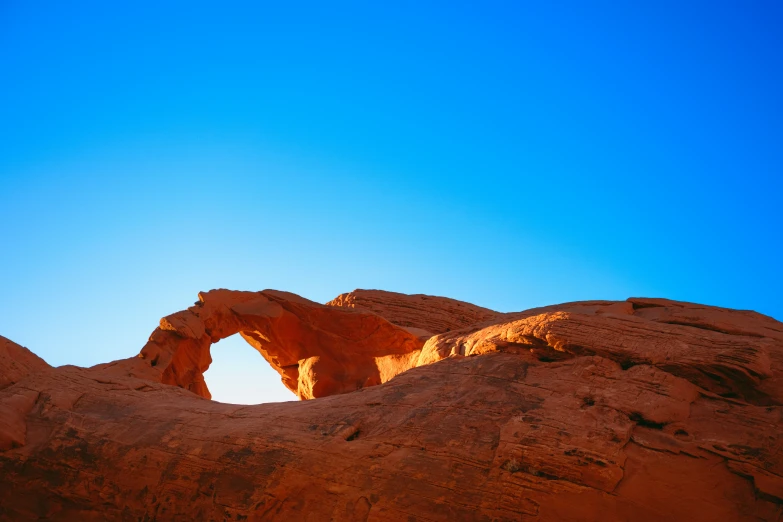 a rock arch in the middle of some rocky terrain