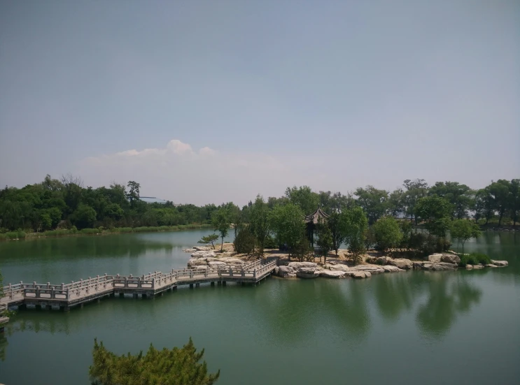a dock along a large lake near a lush green forest