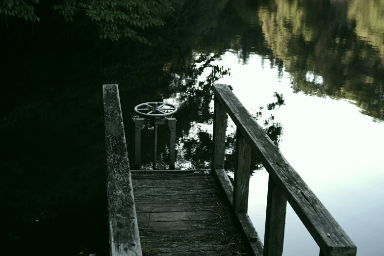 the water is calm and still has a bike parked on it