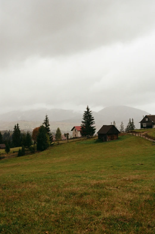 the house is on top of the hill in the far distance