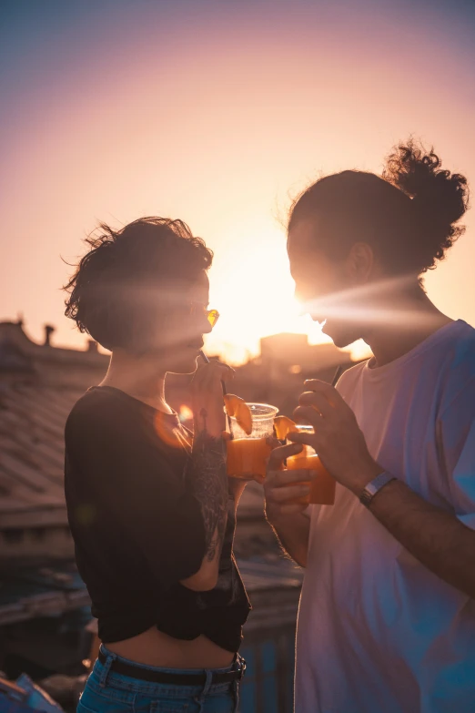 two young women standing on top of a roof