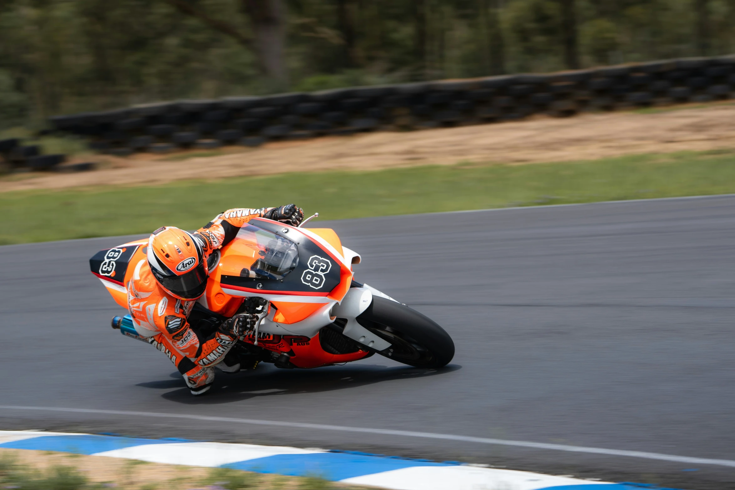 a motorcyclist is driving on the racing track