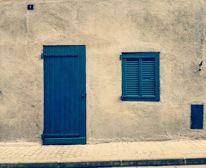 a house with a blue door and window shutters