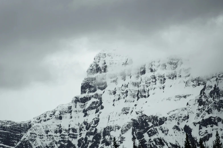 an airplane in flight over mountains in the snow