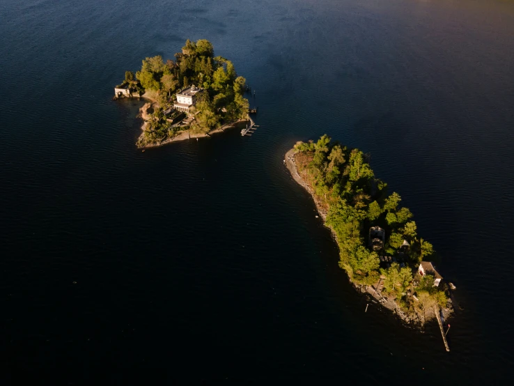 an island with small houses next to the lake