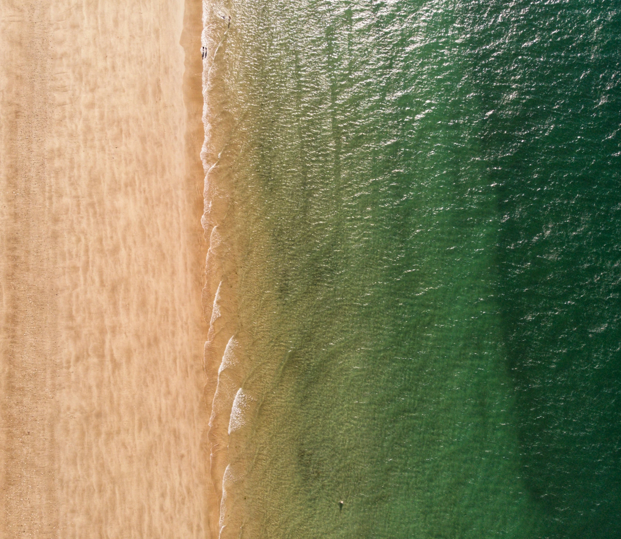 view of a beach with green ocean water