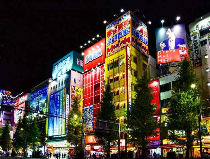 brightly lit buildings in a downtown area at night