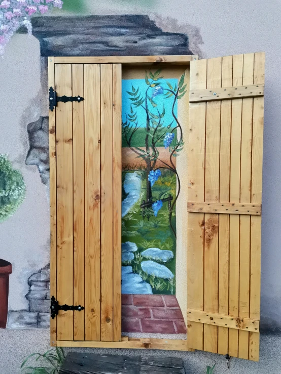 two wooden doors with painting on them and two pots in front of them