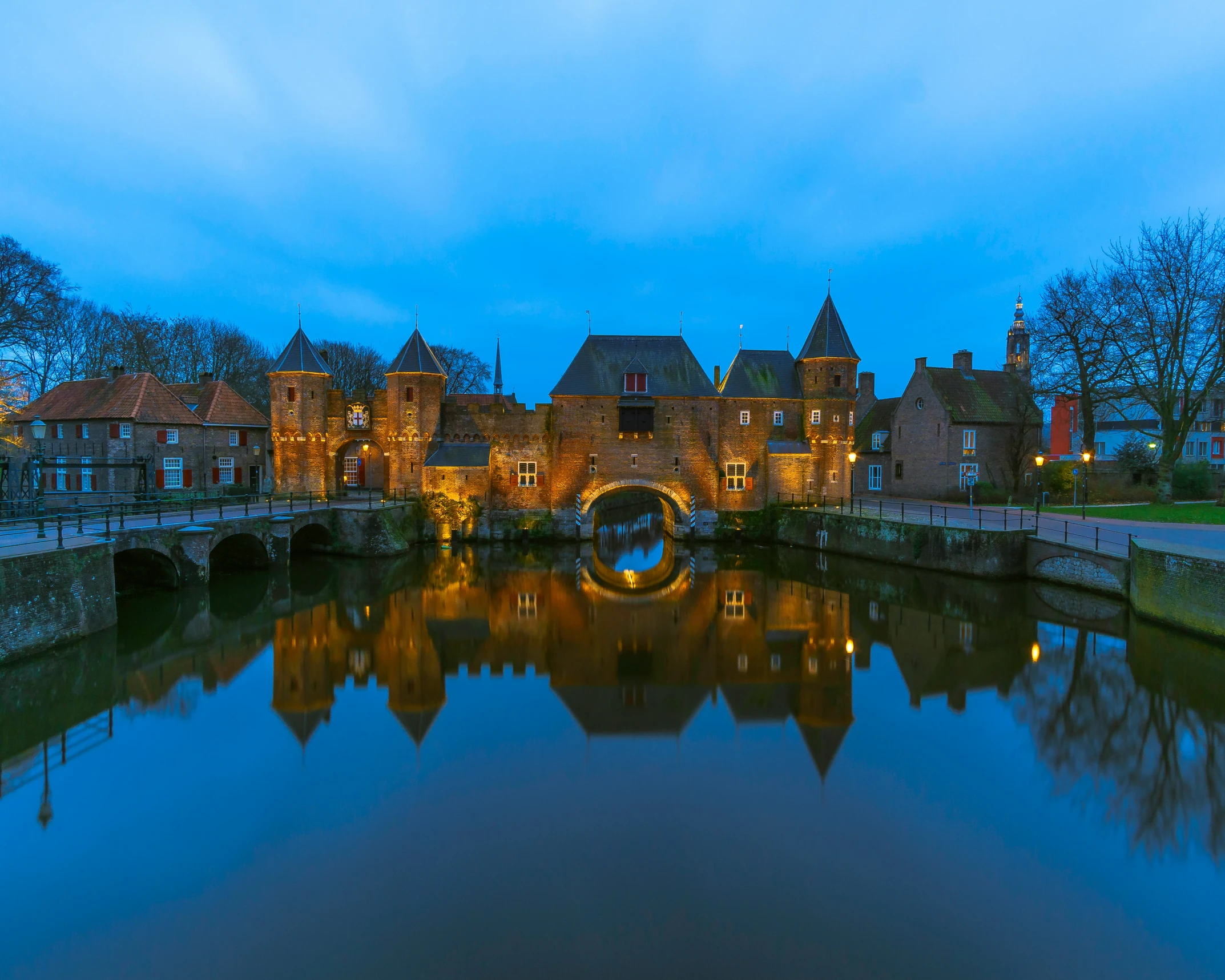 a river and buildings with a bridge over it