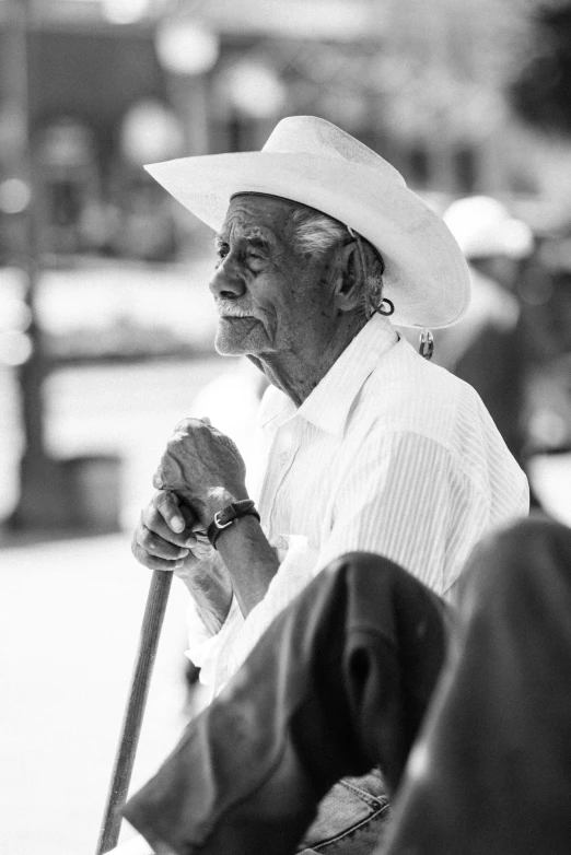 a man with a hat holding a cane