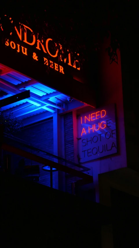 a neon sign lit up the front of a business