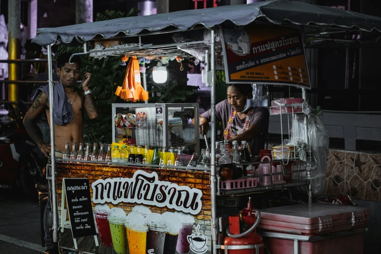 a man is selling juice outside the street