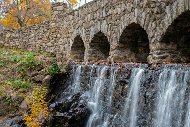 several stone arches over flowing water