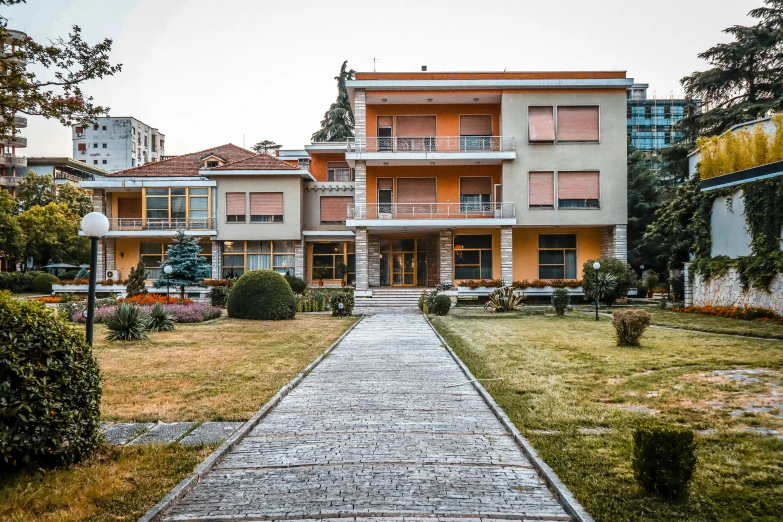 a walkway leads up to a large house