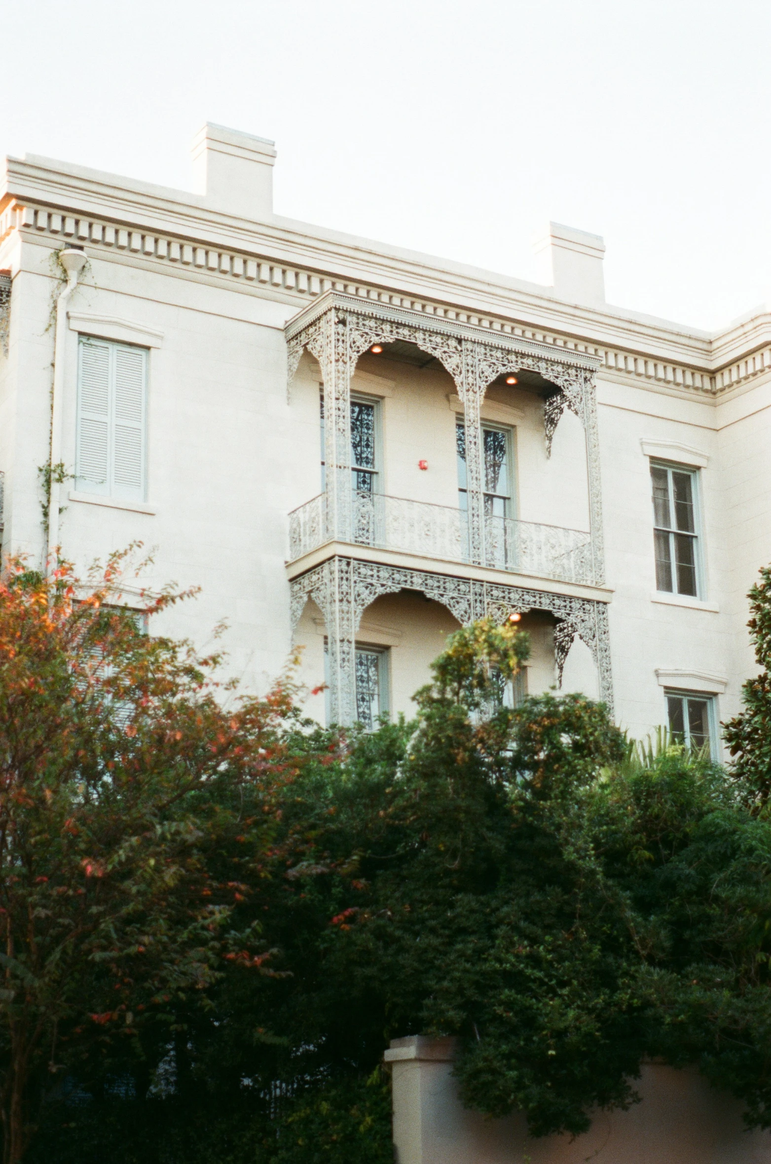 the outside view of a building with trees around it