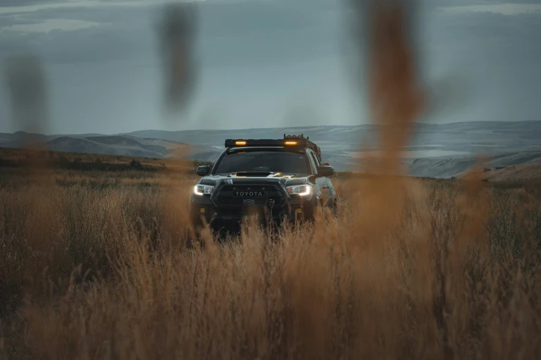 the truck is parked in the middle of the field