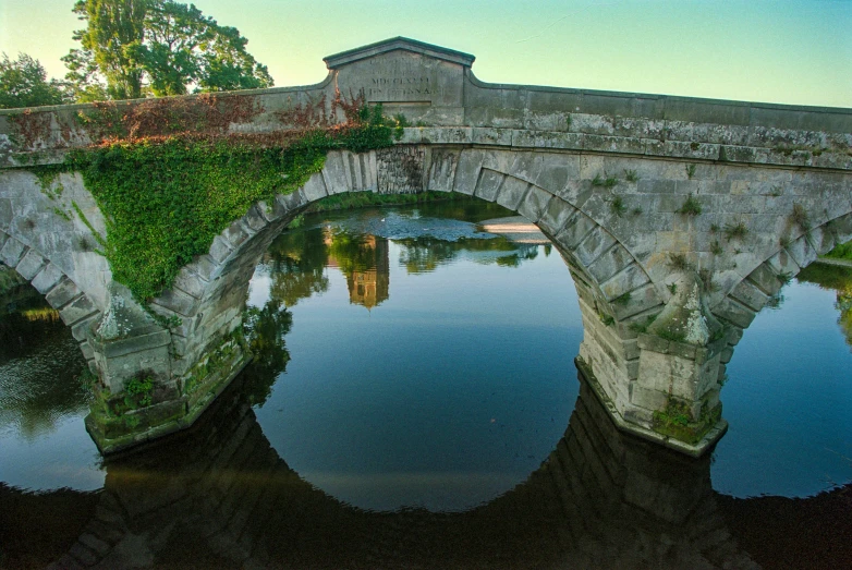 the beautiful bridge is reflecting in the water