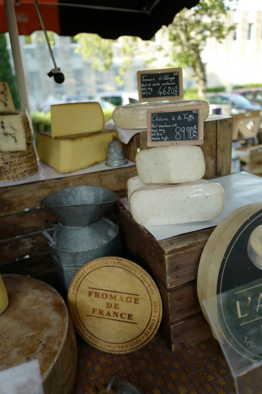 cheese and other foods displayed on display at a market