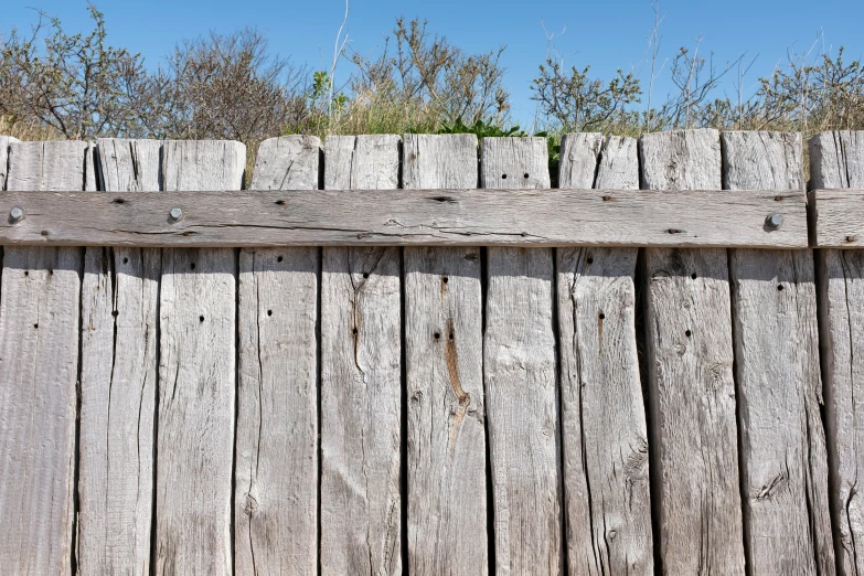 an old fence that is wooden and old