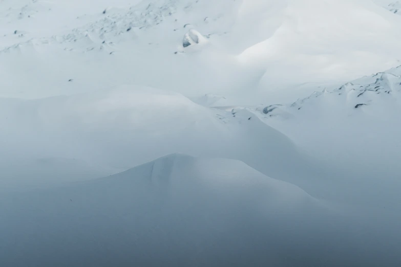 a skier is skiing down a snowy mountain