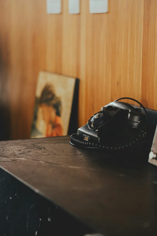 an old fashioned telephone sitting on top of a wooden table