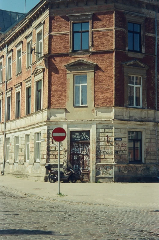 a brick building with a traffic sign in front of it