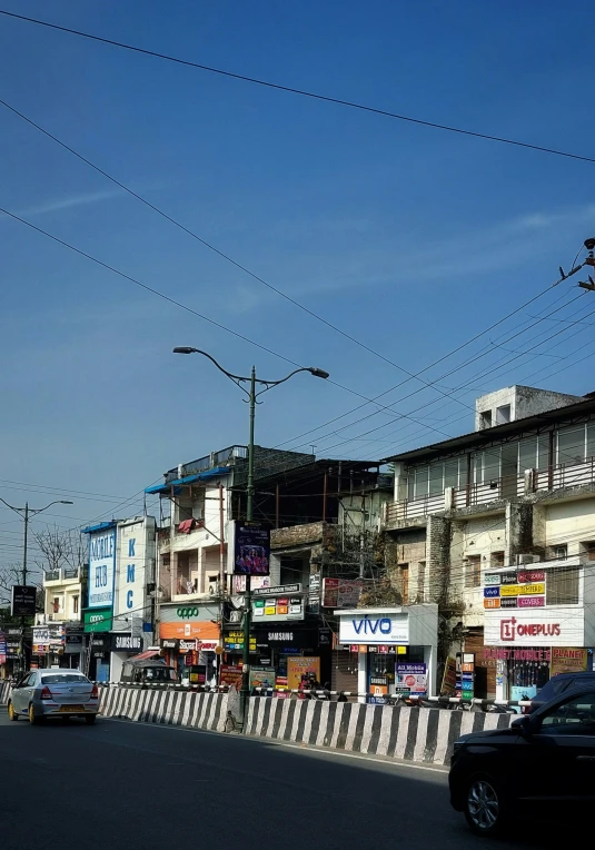 an intersection with cars and traffic lights and buildings