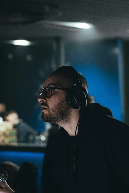 man in front of a computer wearing headphones