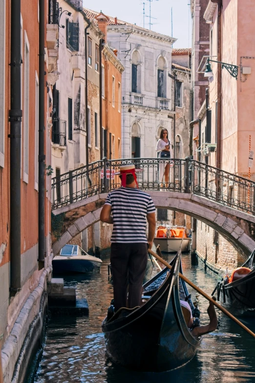 a couple in striped shirts are riding on gondola