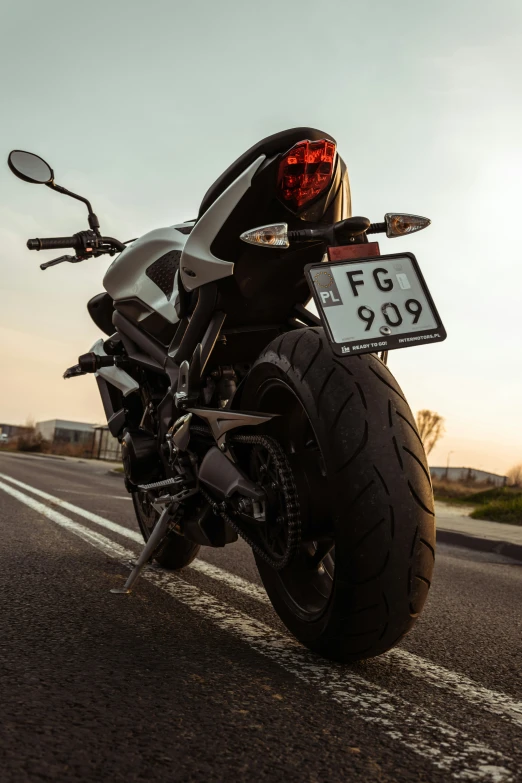 a close - up of the back end of a motorcycle, with its headlights on