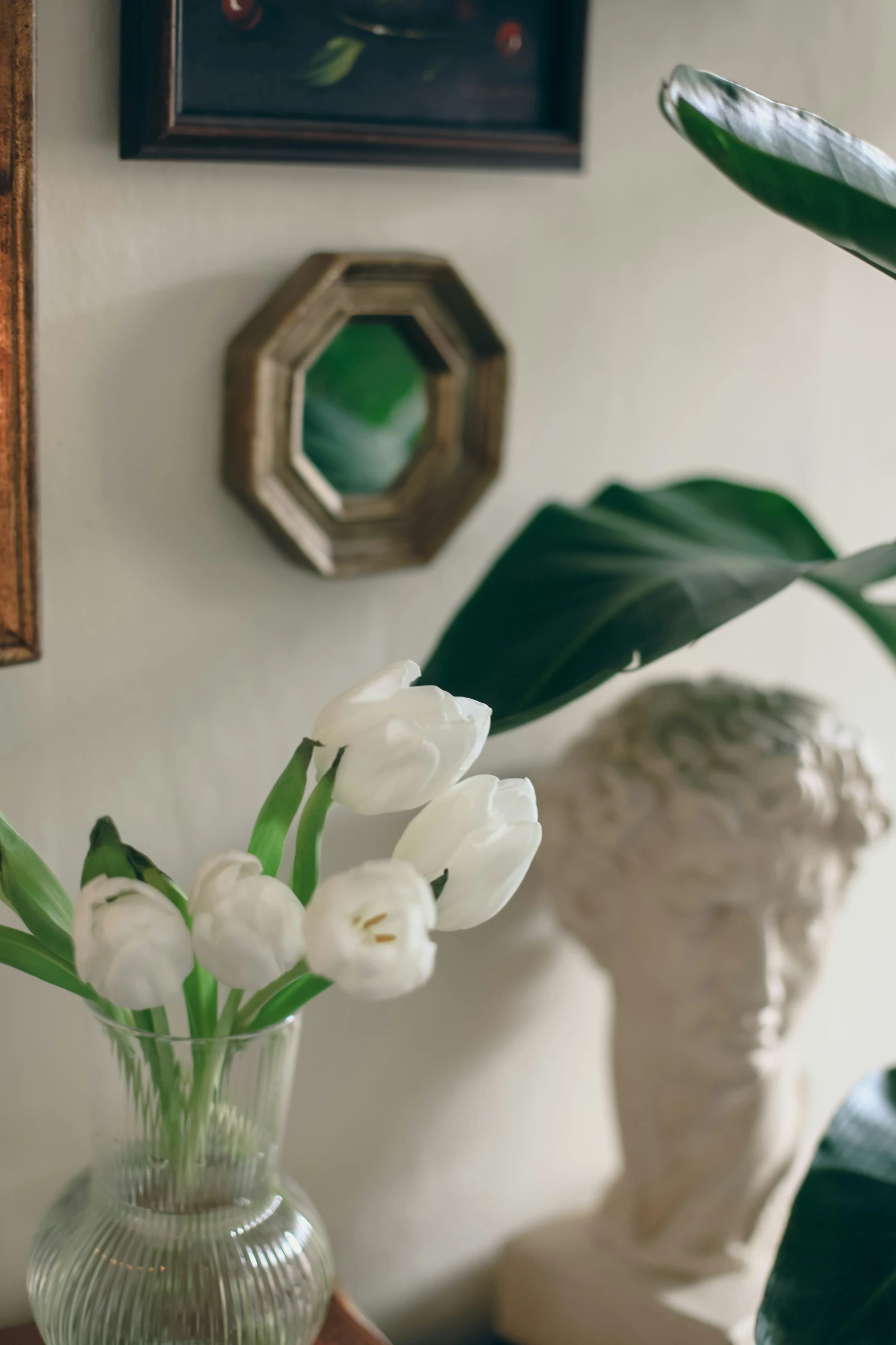 the vase is sitting on a table by the mirror