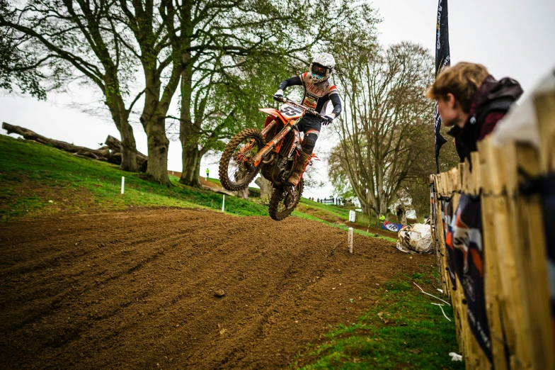 a man on a dirt bike doing a jump