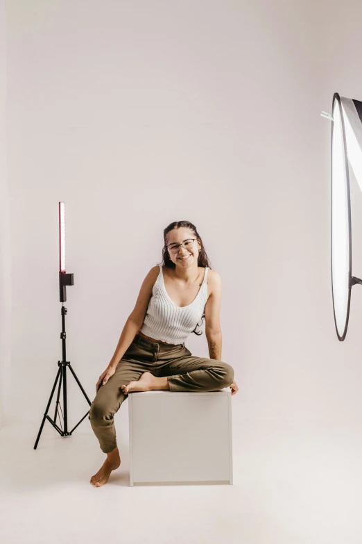 a woman sits in front of three lights