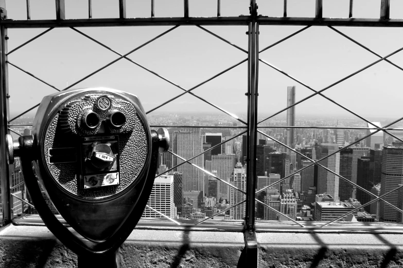 a parking meter with a view of the city behind it