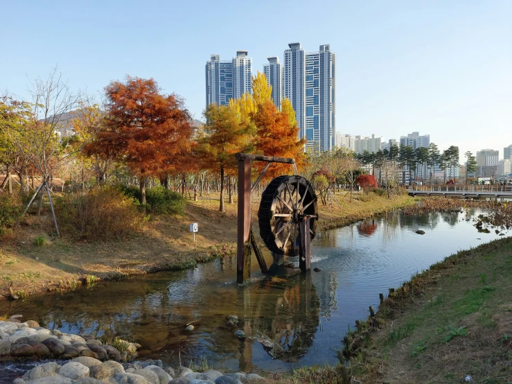 an old water mill is shown in the fall