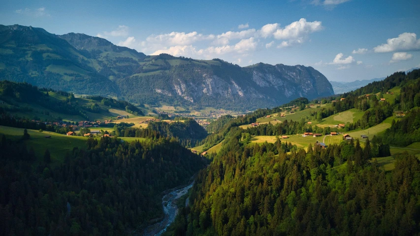 the view from above of a valley surrounded by mountains