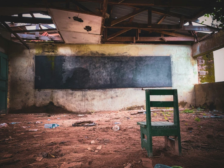 a green chair in an abandoned school