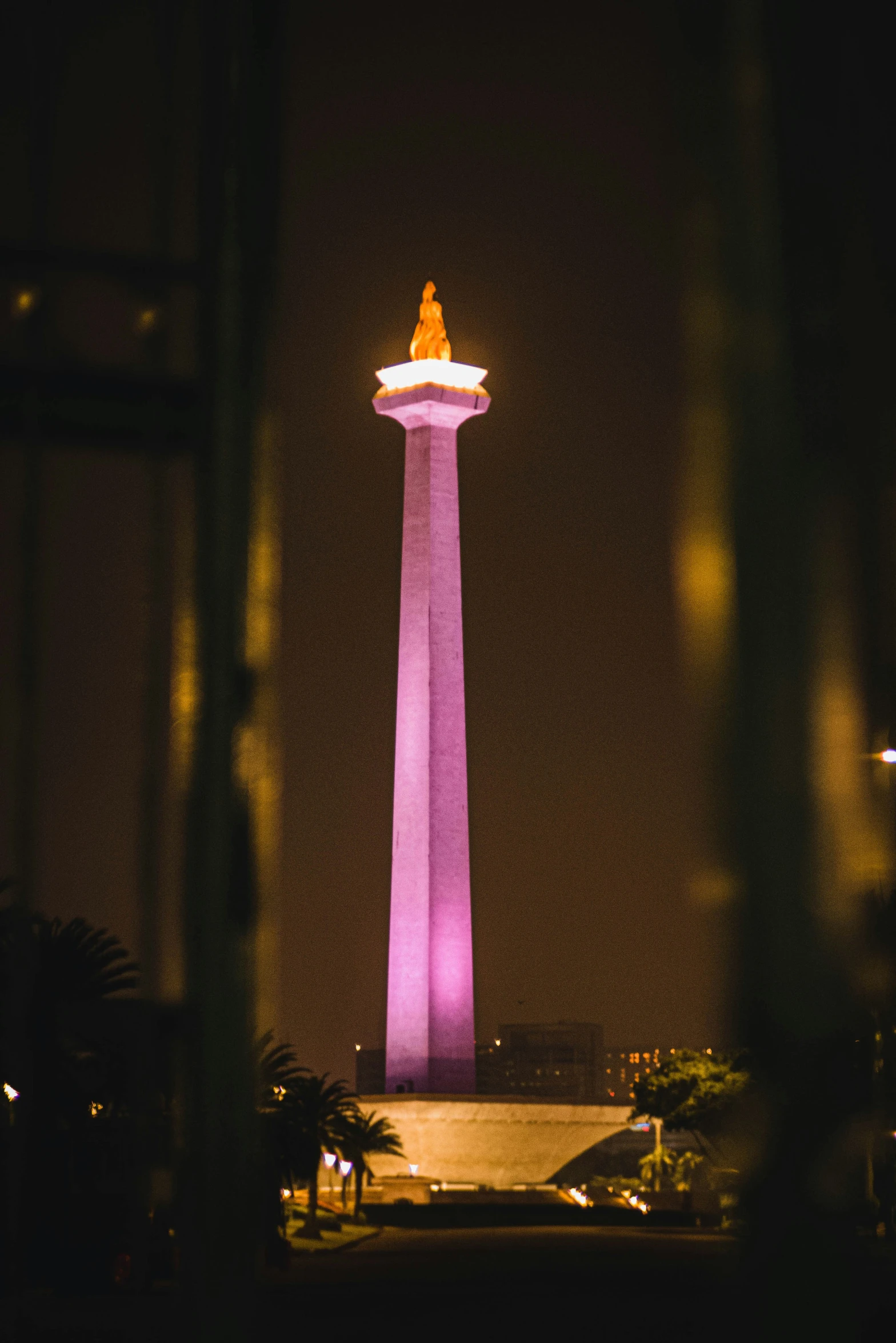 purple light in the sky and a man on a pedestal