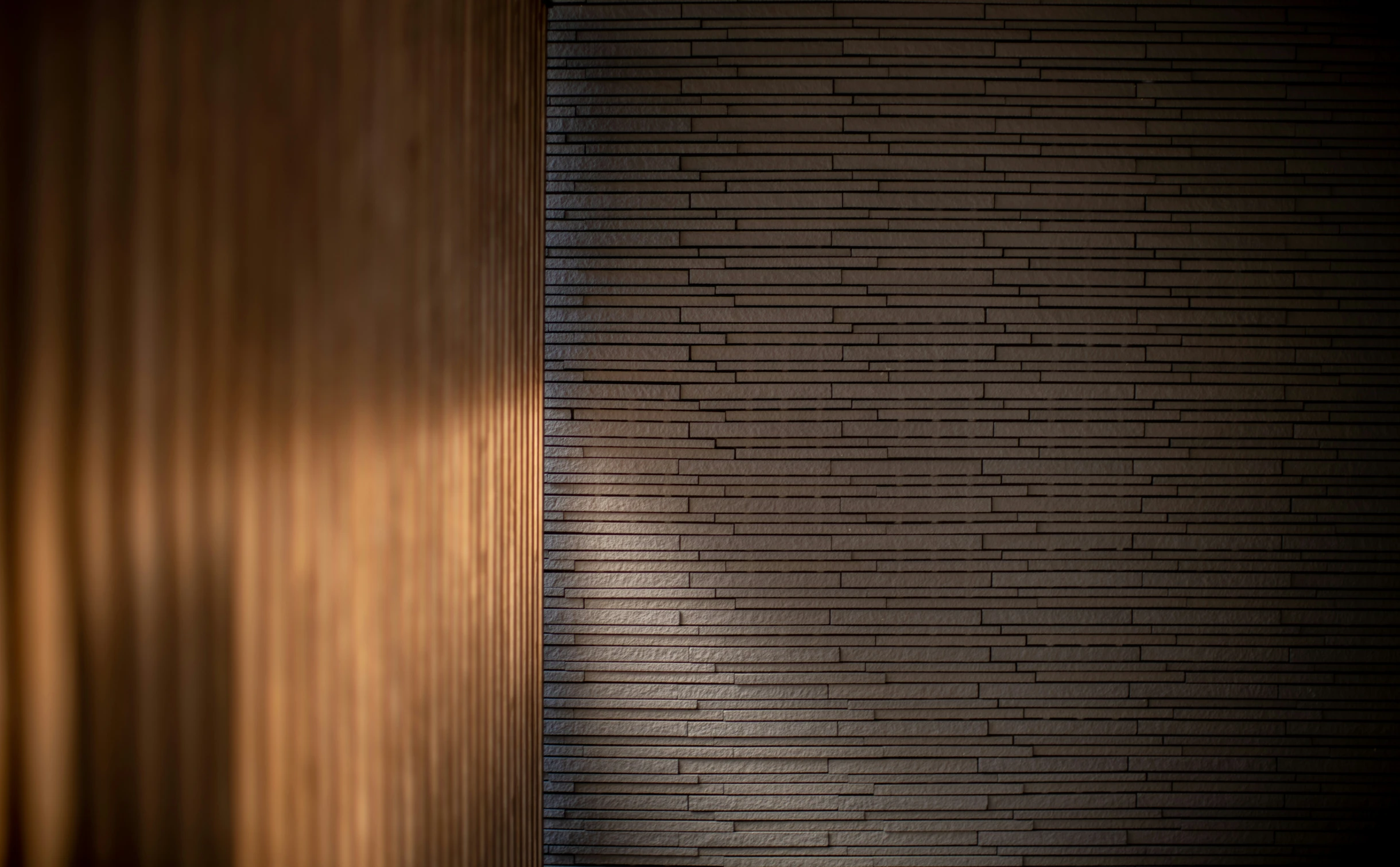 a light shines on the wall of a brick building