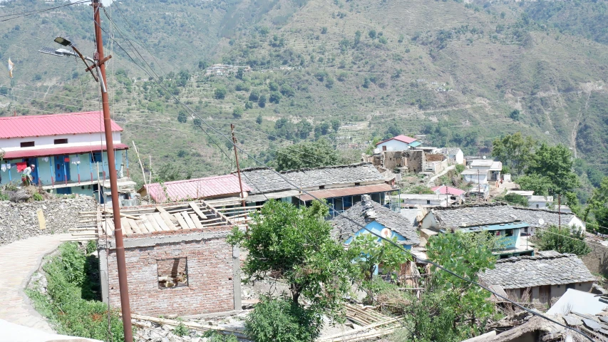 a bird sits atop of the small village that has no roofs