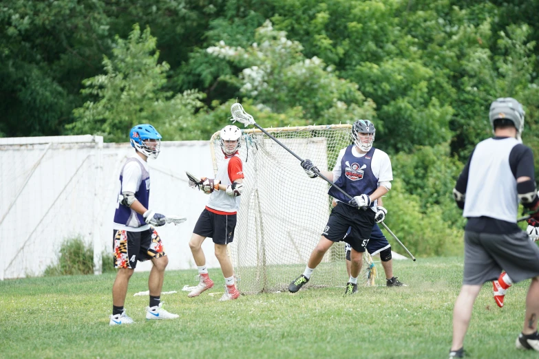 several people wearing sports gear are playing lacrosse