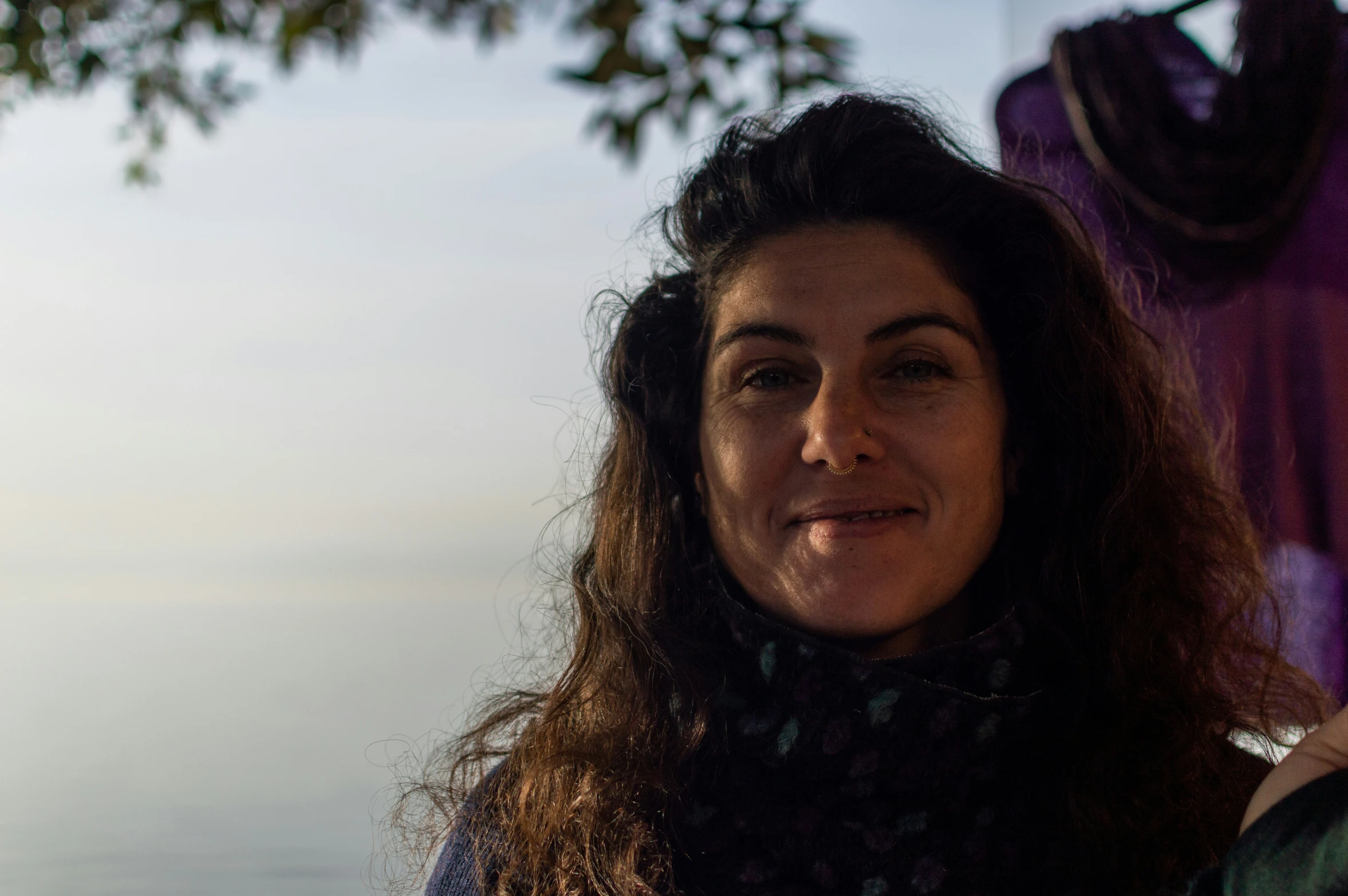 a woman that is sitting down and smiling