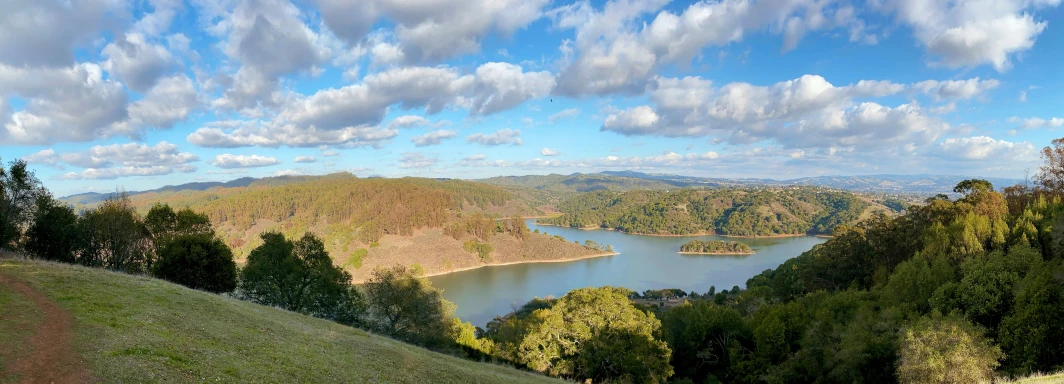 clouds float over the mountains and water