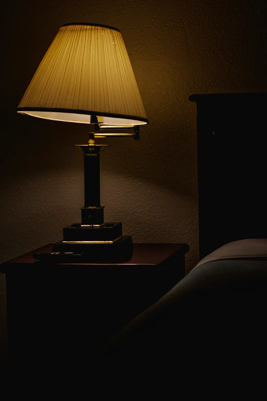 a lamp is sitting on a night stand with a night light on