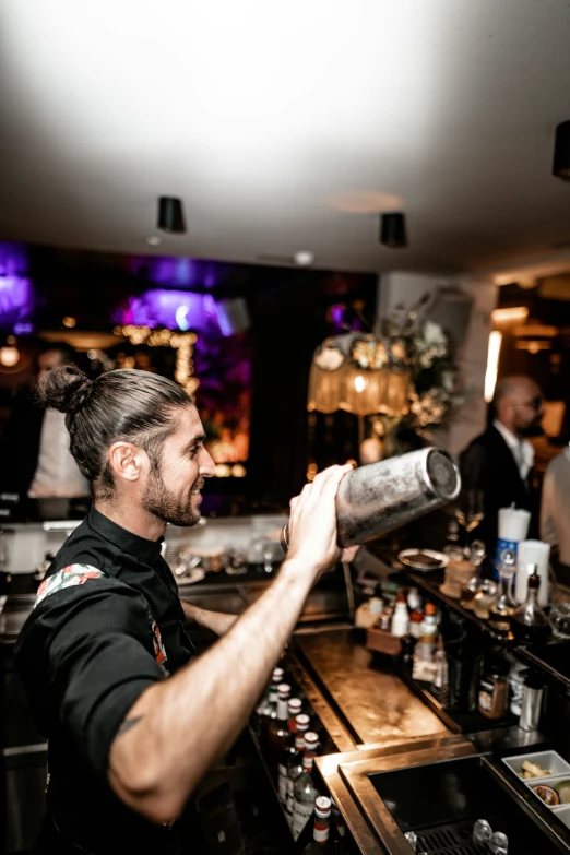 a person at a bar pouring a drink