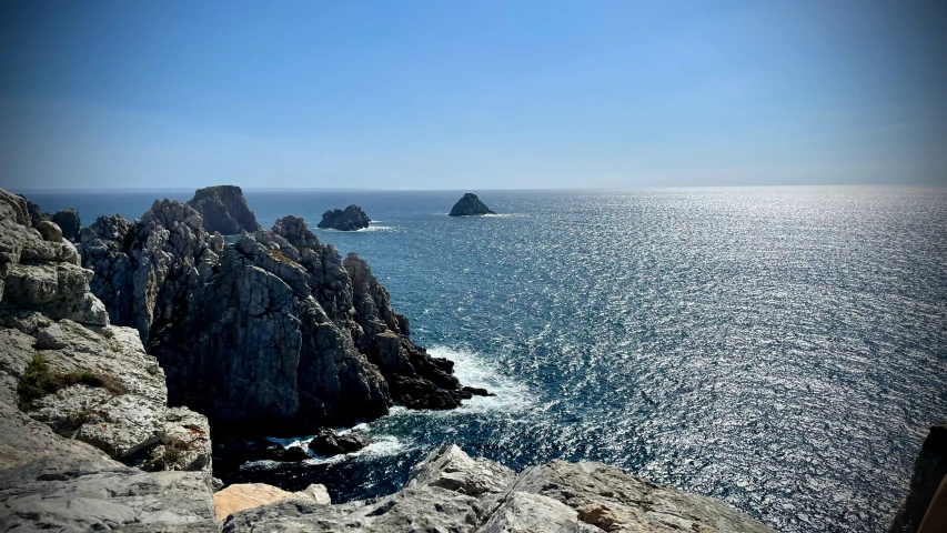 several rocks in the water next to each other